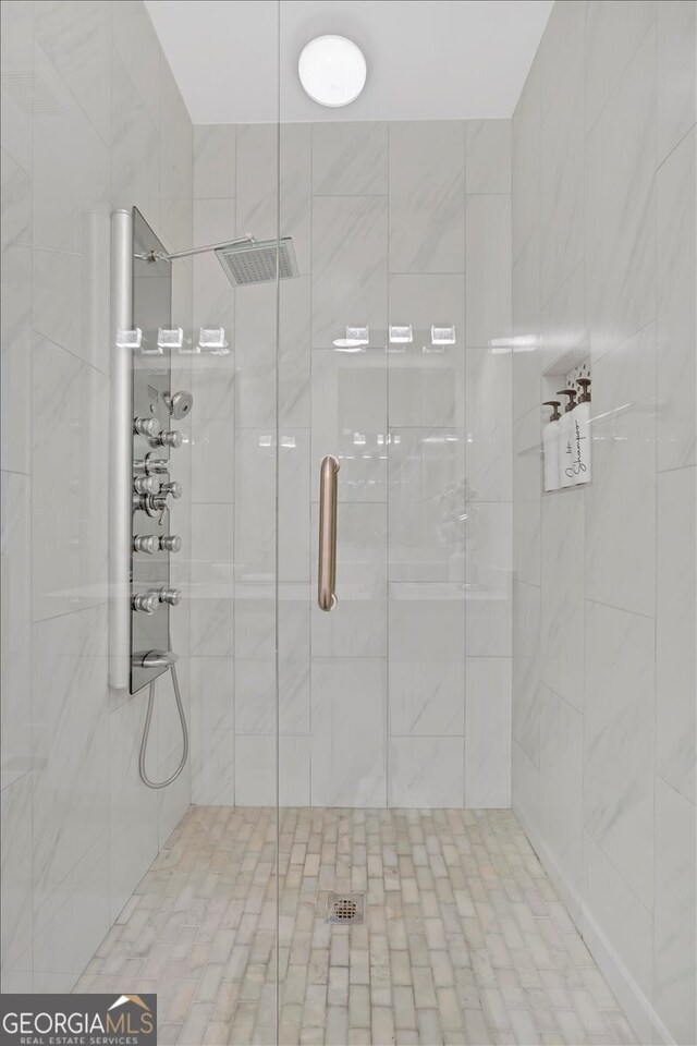 bathroom with a shower with shower door