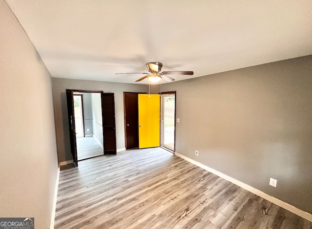 unfurnished bedroom with light hardwood / wood-style floors and ceiling fan