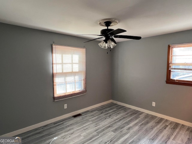 empty room with light hardwood / wood-style flooring and ceiling fan