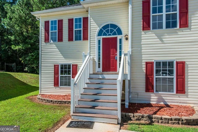 doorway to property with a yard