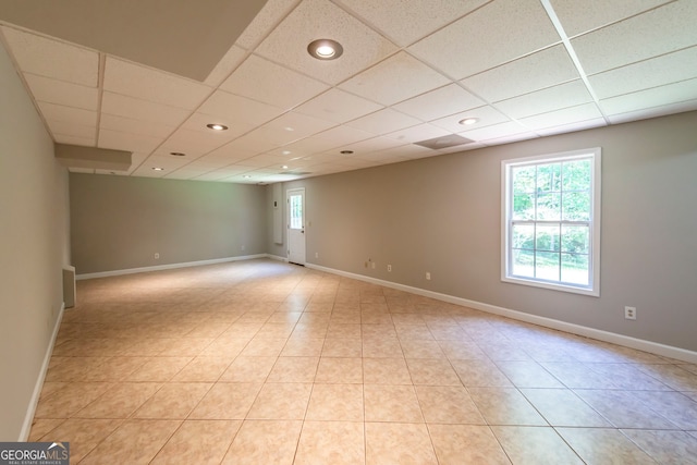 tiled empty room with a drop ceiling