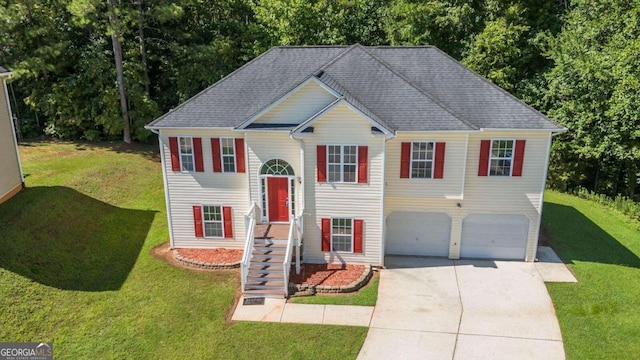 bi-level home with a garage and a front yard