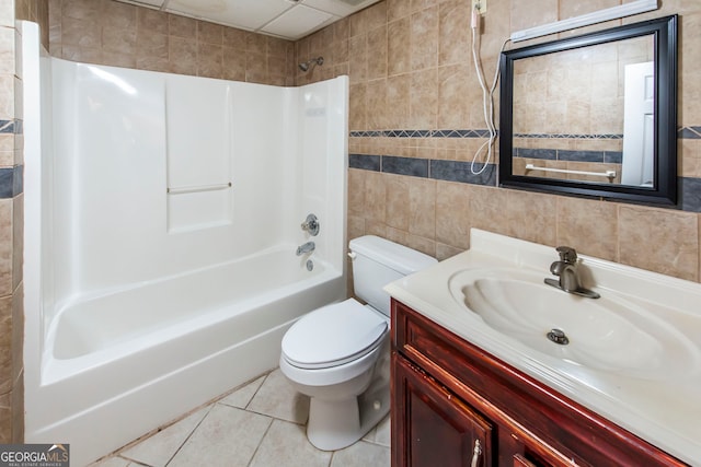 full bathroom featuring toilet, tile walls, tile patterned flooring, vanity, and tub / shower combination