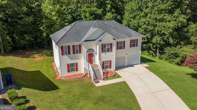 view of front of house with a garage and a front yard