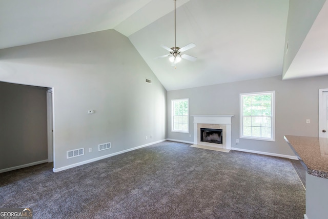 unfurnished living room featuring high vaulted ceiling, dark carpet, and ceiling fan