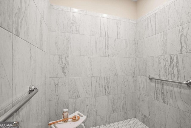 bathroom with tiled shower