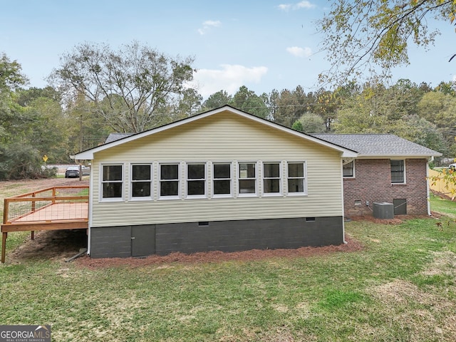 view of property exterior featuring a yard and a wooden deck