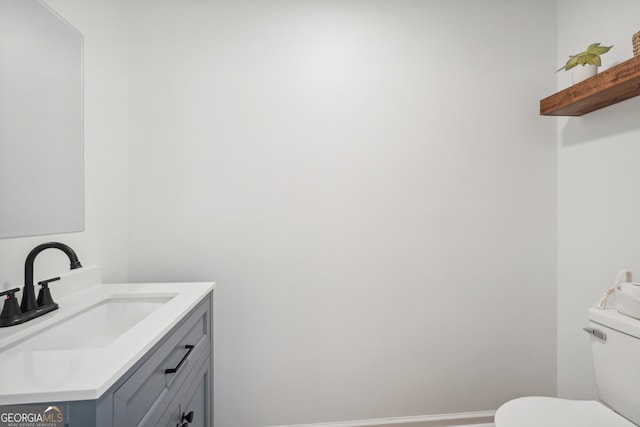 bathroom featuring vanity and toilet