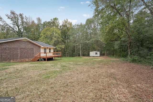 view of yard with a wooden deck and a storage unit