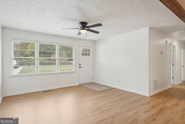 entryway with light wood-type flooring, a textured ceiling, and ceiling fan