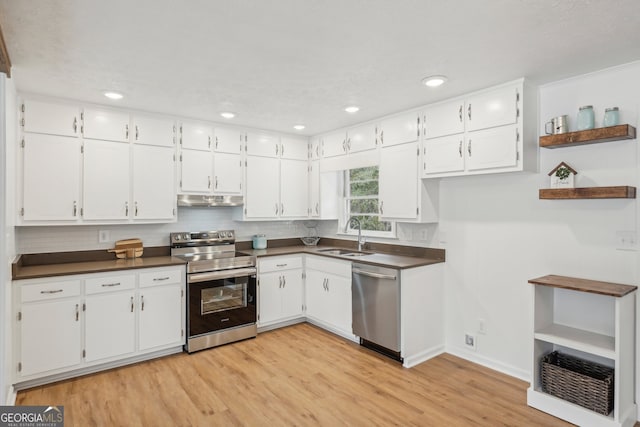 kitchen featuring white cabinetry, light wood-type flooring, appliances with stainless steel finishes, and sink