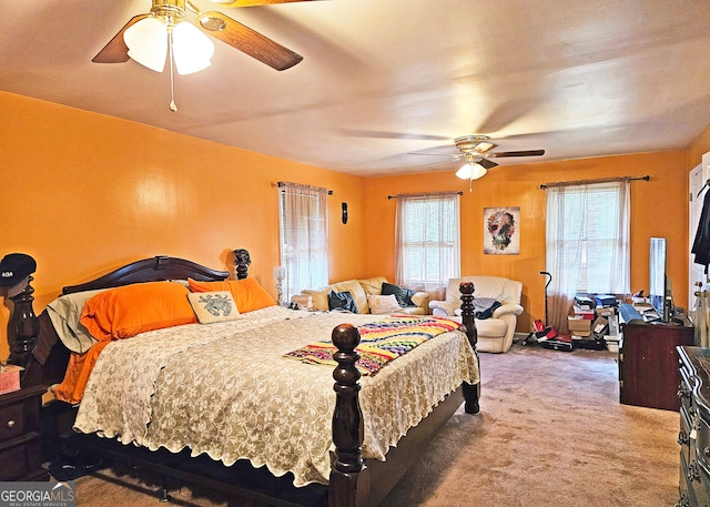 bedroom with ceiling fan, multiple windows, and carpet