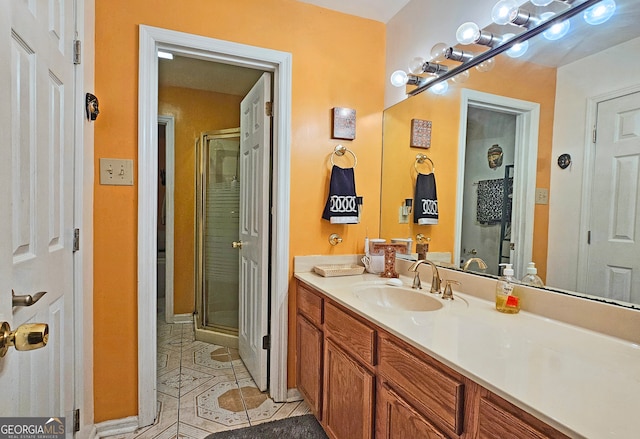 bathroom featuring vanity, tile patterned flooring, and a shower with shower door