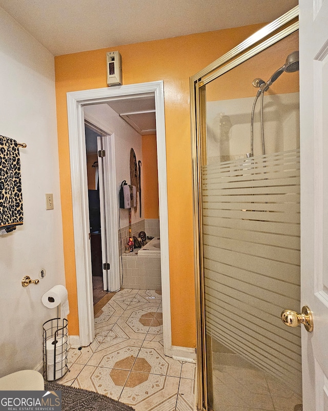 bathroom with tile patterned flooring and separate shower and tub