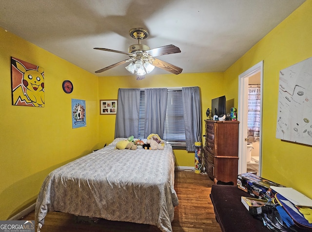 bedroom featuring connected bathroom, dark hardwood / wood-style flooring, and ceiling fan