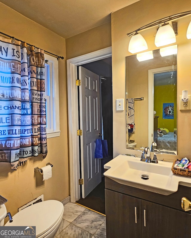 bathroom featuring vanity and toilet