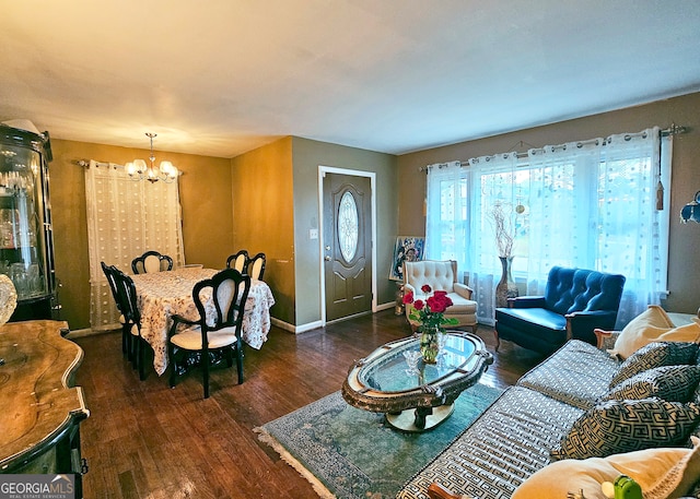 living room with a chandelier and dark hardwood / wood-style flooring