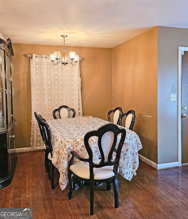 dining room featuring dark hardwood / wood-style floors and a chandelier