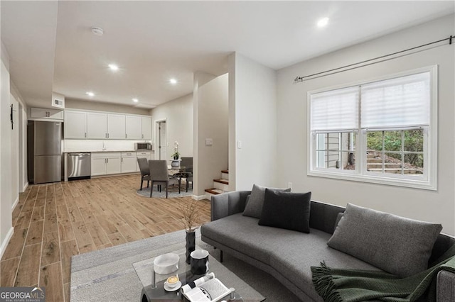 living room with sink and light hardwood / wood-style floors