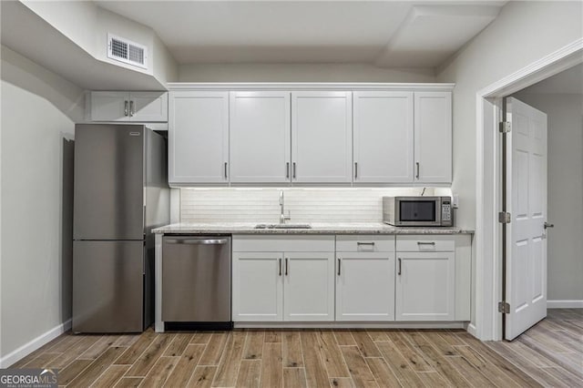 kitchen featuring white cabinetry, stainless steel appliances, and sink