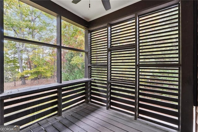 unfurnished sunroom featuring a wealth of natural light and ceiling fan