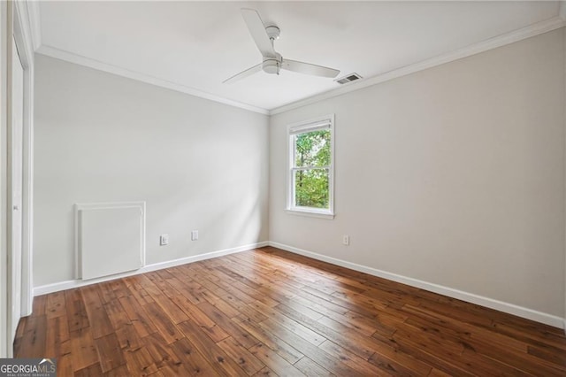 empty room with dark wood-type flooring, ceiling fan, and crown molding