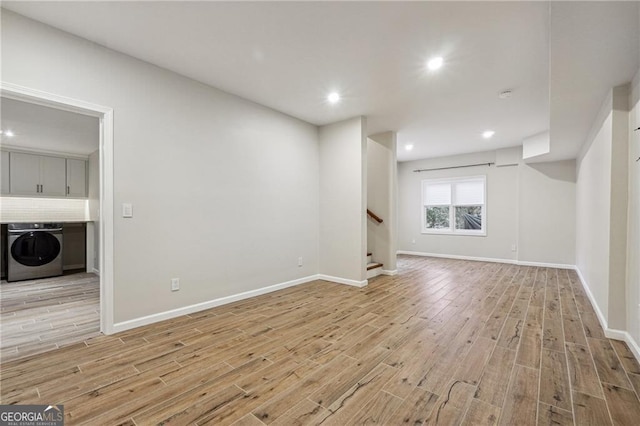 interior space featuring light wood-type flooring and washer / dryer