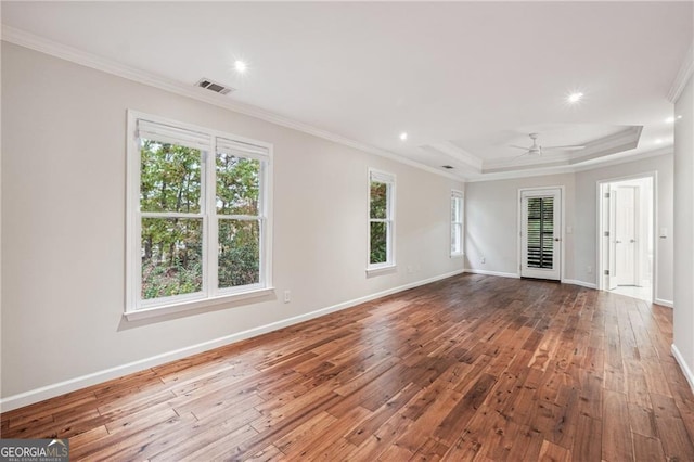 unfurnished room featuring hardwood / wood-style floors, a wealth of natural light, and crown molding