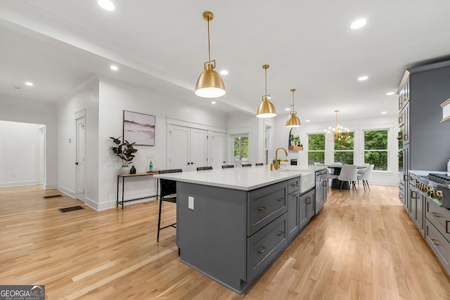 dining room featuring ornamental molding, an inviting chandelier, and light hardwood / wood-style floors