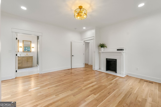 bathroom with a shower with shower door, vanity, toilet, and crown molding