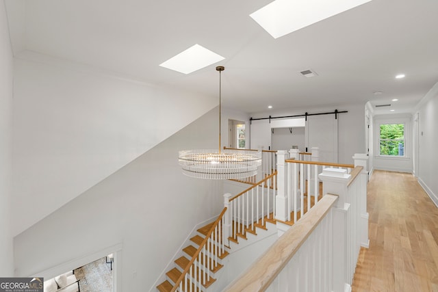 empty room featuring light hardwood / wood-style flooring and a chandelier