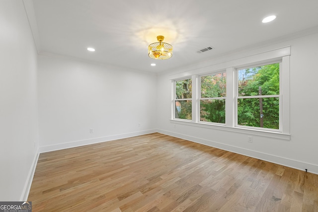 unfurnished bedroom featuring light wood-type flooring and crown molding