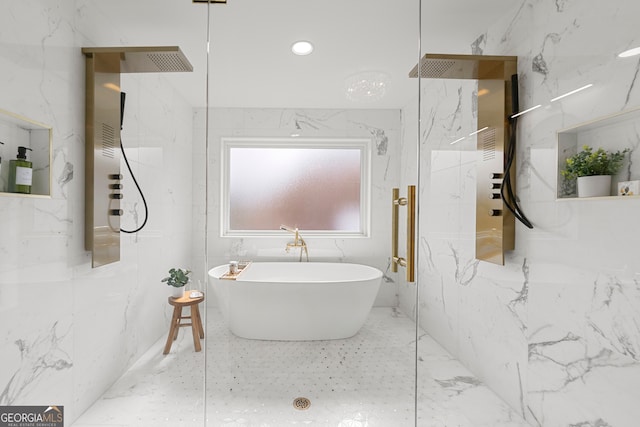 bathroom with tile walls and a tub