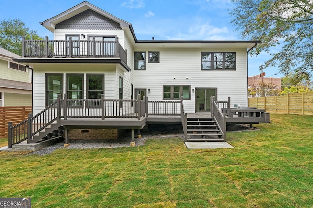 back of house featuring a deck, a lawn, and central AC