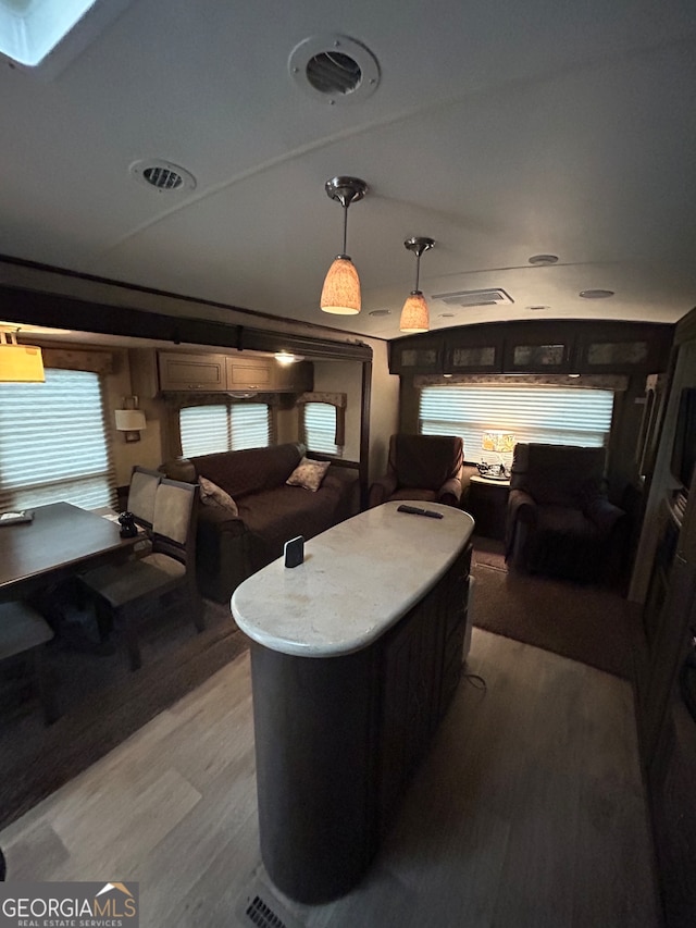 game room with a skylight and hardwood / wood-style flooring