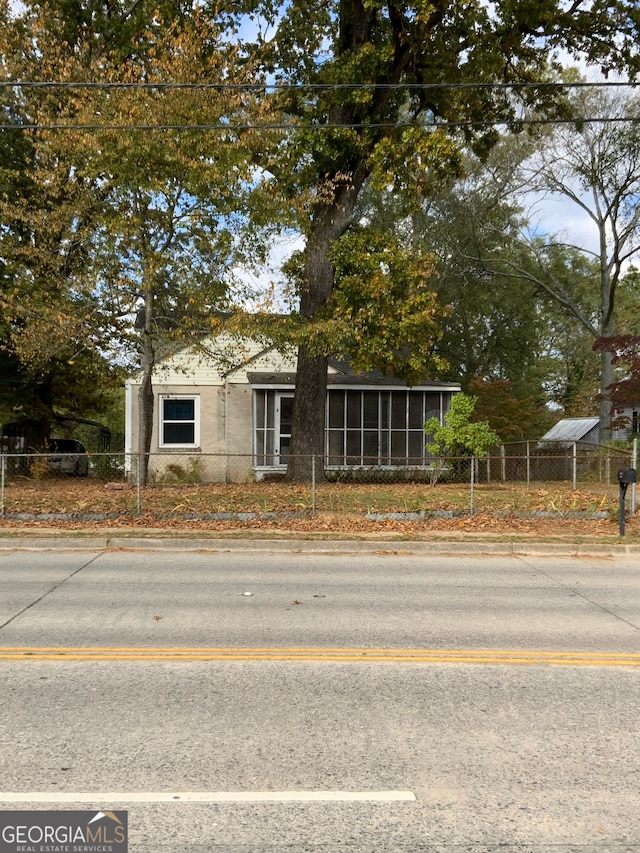 view of front of home with a sunroom