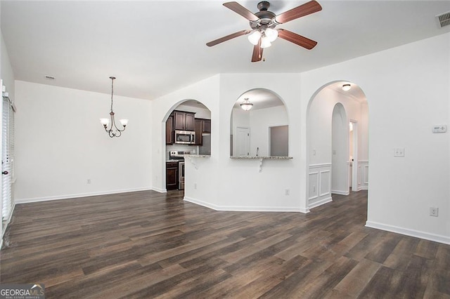 unfurnished living room with dark wood-type flooring and ceiling fan with notable chandelier