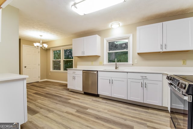 kitchen featuring light hardwood / wood-style floors, stainless steel appliances, sink, white cabinetry, and decorative light fixtures