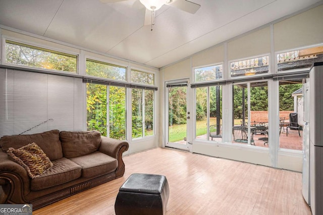 sunroom with ceiling fan, a healthy amount of sunlight, and vaulted ceiling