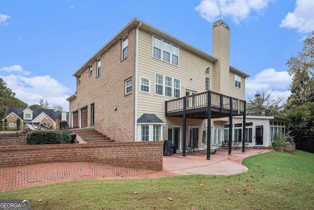 rear view of property featuring a lawn and a patio