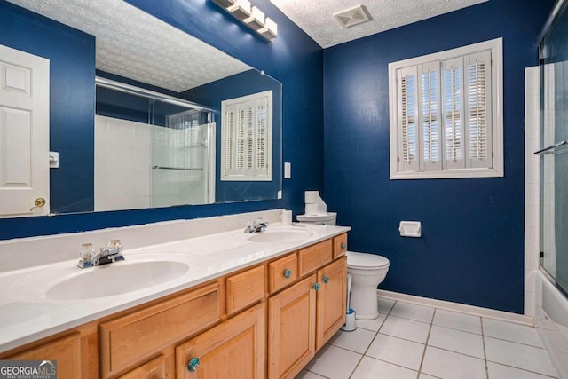 full bathroom with enclosed tub / shower combo, toilet, tile patterned floors, a textured ceiling, and vanity