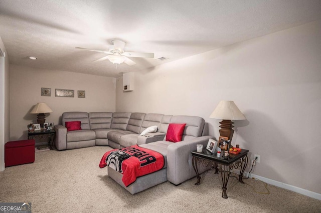 carpeted living room featuring a textured ceiling and ceiling fan