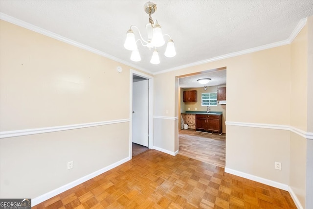 unfurnished dining area featuring sink, a textured ceiling, an inviting chandelier, light parquet floors, and crown molding