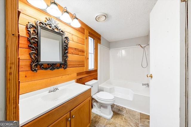 full bathroom with vanity, a textured ceiling, toilet, and tub / shower combination