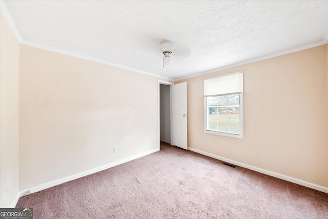 unfurnished room featuring ornamental molding, a textured ceiling, and carpet