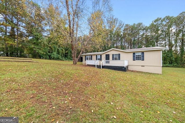 exterior space featuring a lawn and a deck