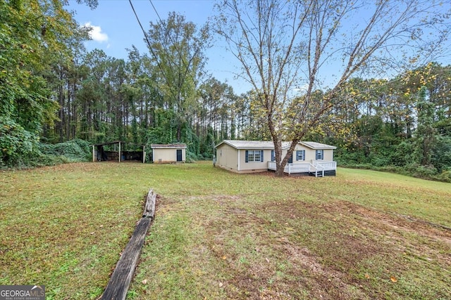 view of yard with a storage shed and a deck