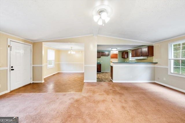 unfurnished living room with ornamental molding, ceiling fan with notable chandelier, a textured ceiling, carpet, and vaulted ceiling with beams