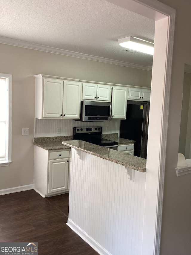 kitchen with black appliances, white cabinetry, a kitchen bar, dark hardwood / wood-style floors, and stone countertops