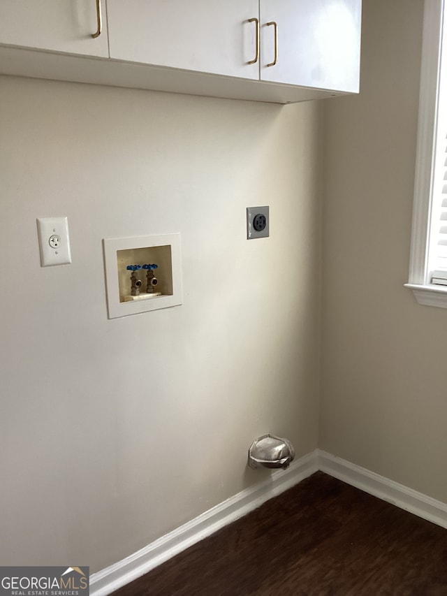 clothes washing area with cabinets, hookup for a washing machine, electric dryer hookup, and dark hardwood / wood-style flooring